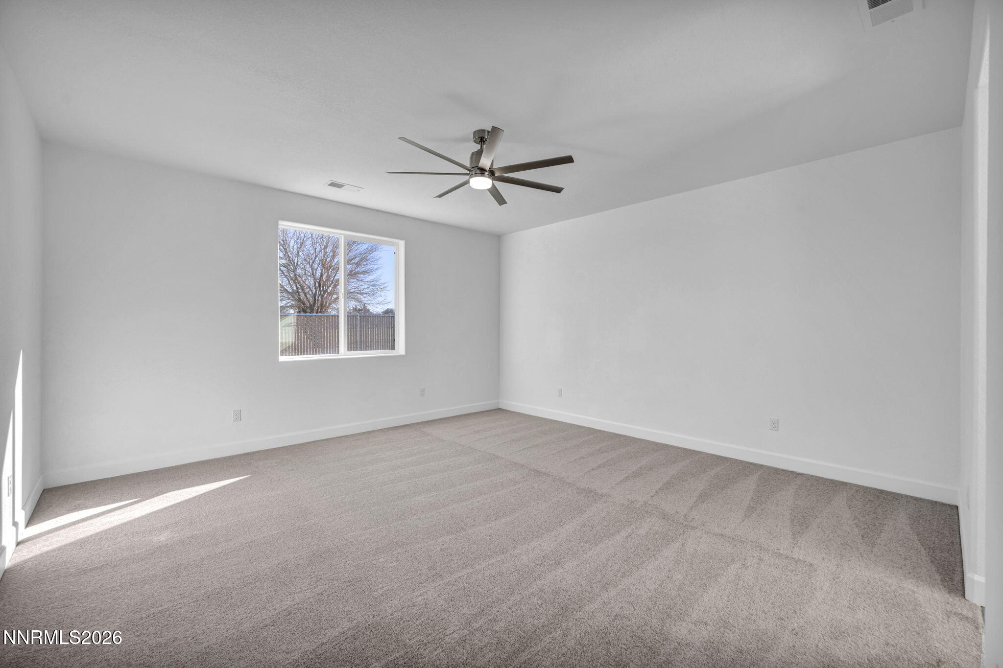 3659 Carson Way, Unit LOT 117 Fernley, NV 89408 - Photo 12 of 24 an empty room with windows and ceiling fan