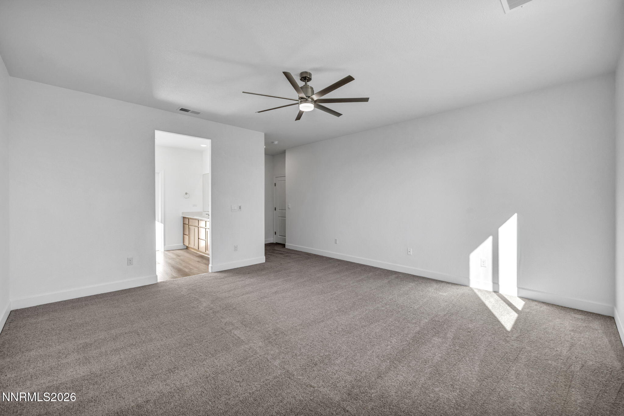 3659 Carson Way, Unit LOT 117 Fernley, NV 89408 - Photo 13 of 24 a view of an empty room with a ceiling fan