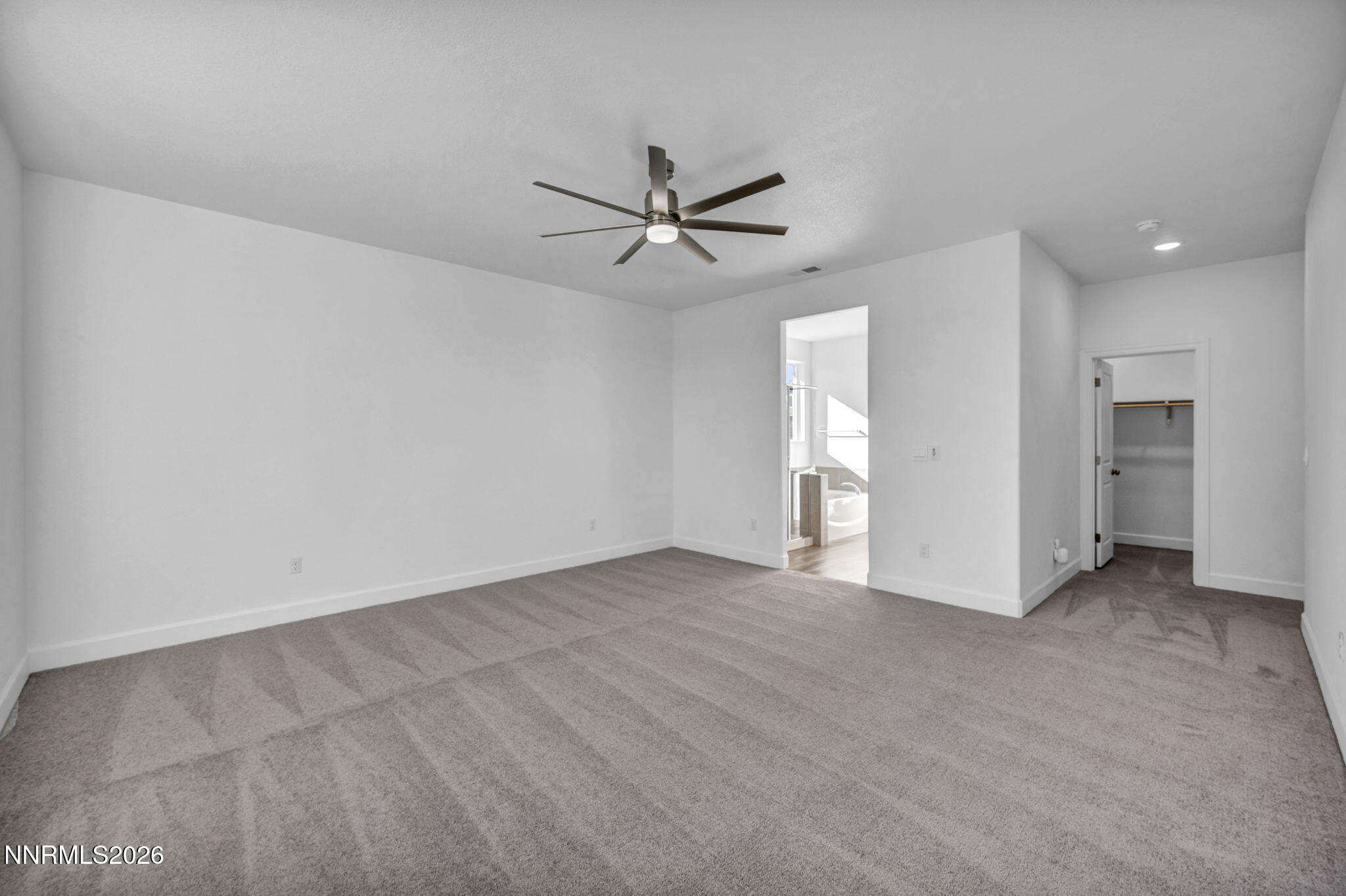 3659 Carson Way, Unit LOT 117 Fernley, NV 89408 - Photo 14 of 24 an empty room with a window and a ceiling fan