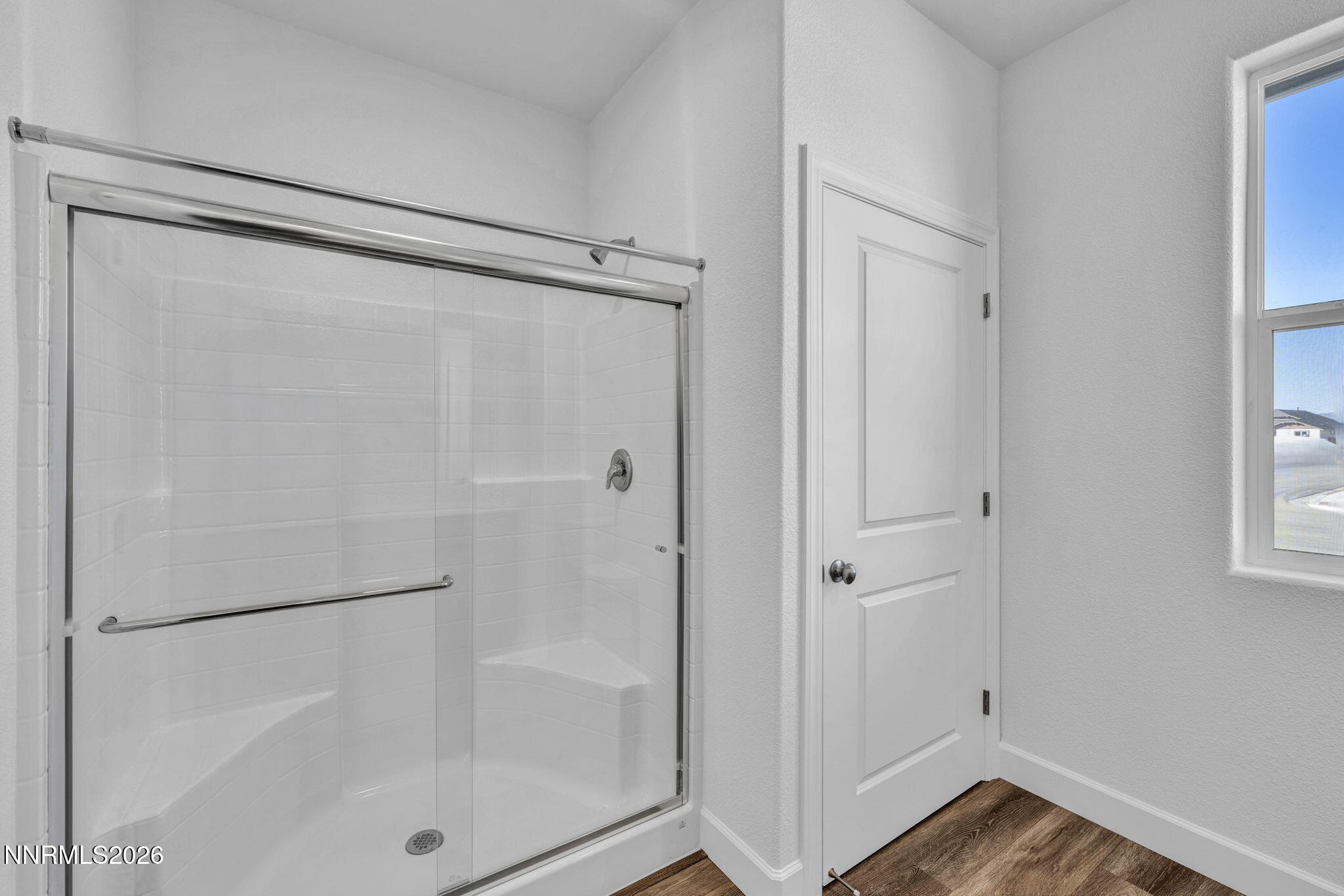 3659 Carson Way, Unit LOT 117 Fernley, NV 89408 - Photo 23 of 24 a bathroom with a glass shower door