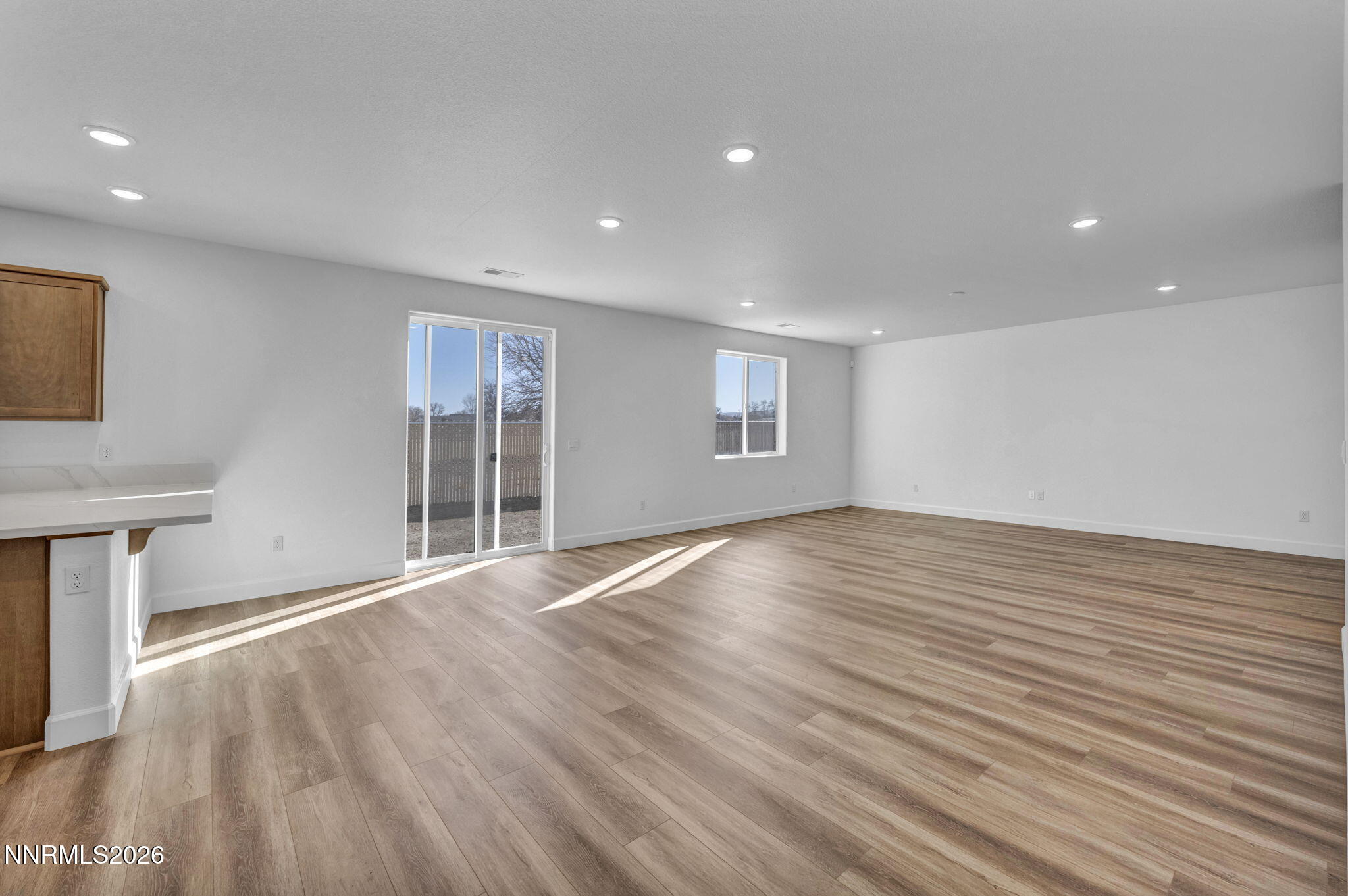 3659 Carson Way, Unit LOT 117 Fernley, NV 89408 - Photo 7 of 24 a view of an empty room with wooden floor and a window