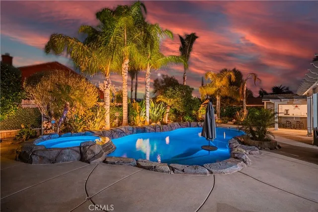 a view of a backyard with swimming pool