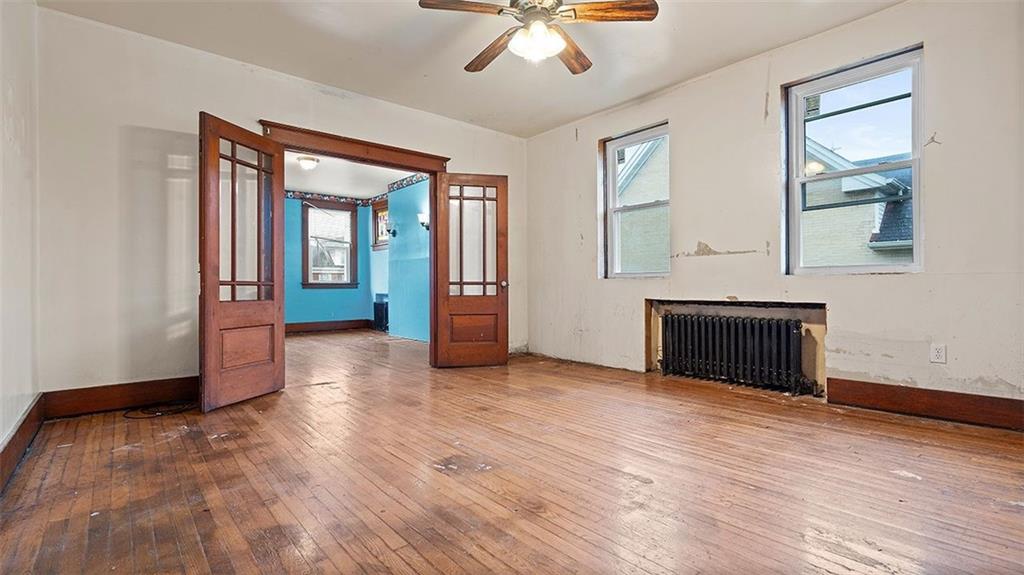 315 Catherine Street McKees Rocks, PA 15136 - Photo 11 of 38 wooden floor fireplace and windows in an empty room