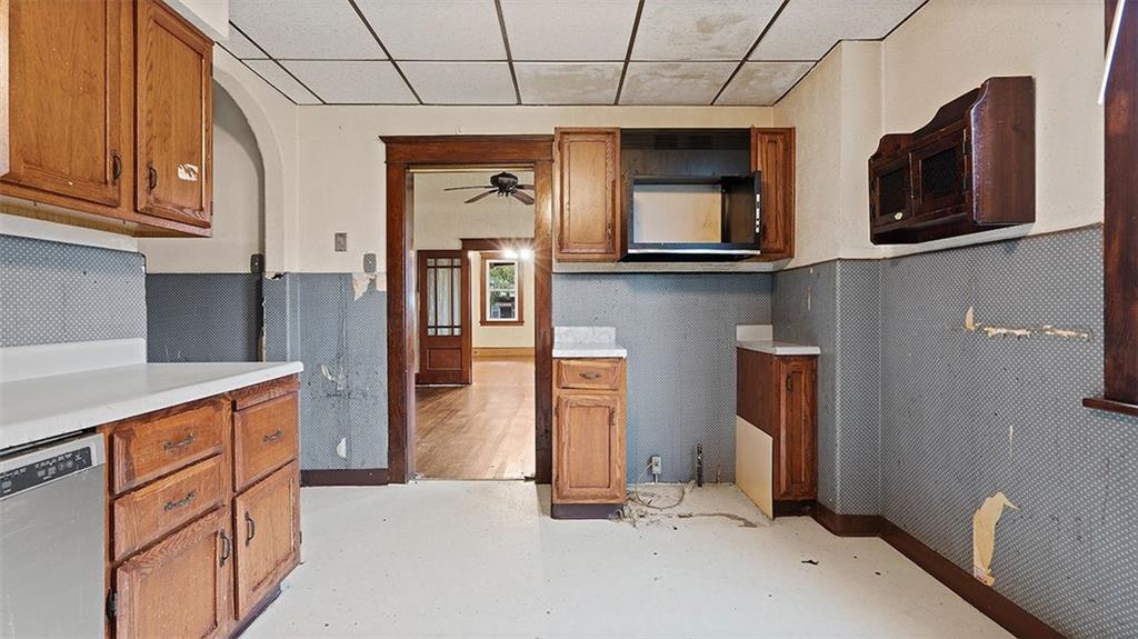 315 Catherine Street McKees Rocks, PA 15136 - Photo 13 of 38 a kitchen with stainless steel appliances granite countertop a refrigerator a stove top oven a sink and dishwasher