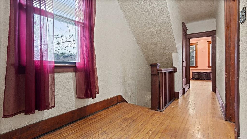 315 Catherine Street McKees Rocks, PA 15136 - Photo 16 of 38 a view of a hallway with wooden floor and windows