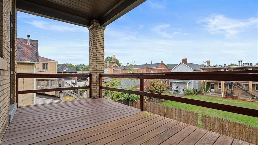 315 Catherine Street McKees Rocks, PA 15136 - Photo 27 of 38 a view of a balcony with wooden floor chairs and ocean view