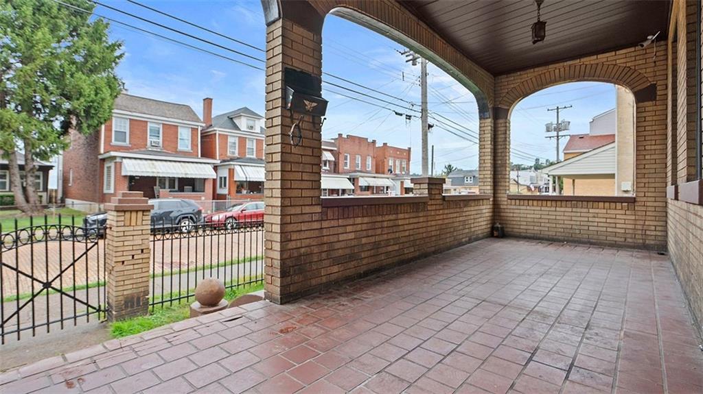 315 Catherine Street McKees Rocks, PA 15136 - Photo 3 of 38 a view of a porch with wooden fence and trees
