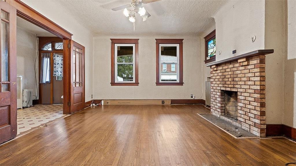 315 Catherine Street McKees Rocks, PA 15136 - Photo 6 of 38 an empty room with wooden floor and windows