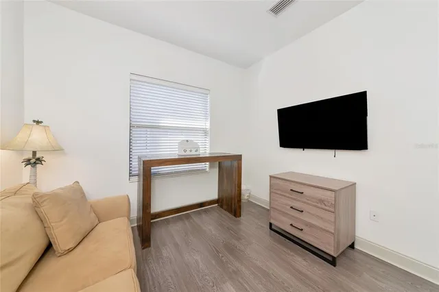 a view of a garden with a bench and potted plants