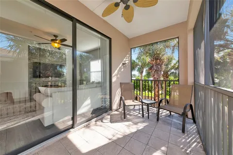 an aerial view of a house with a swimming pool and outdoor seating