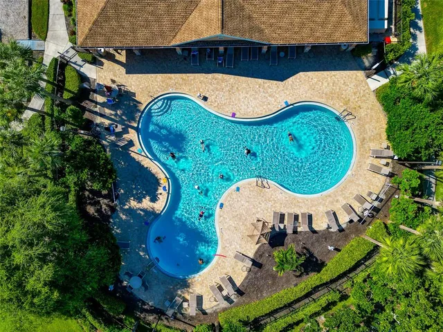 an aerial view of a house with a garden and lake view