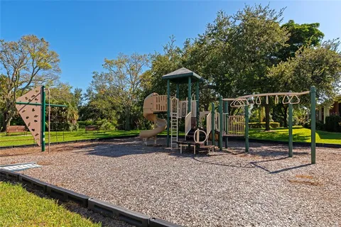 an aerial view of a city with lots of residential buildings ocean and mountain view in back