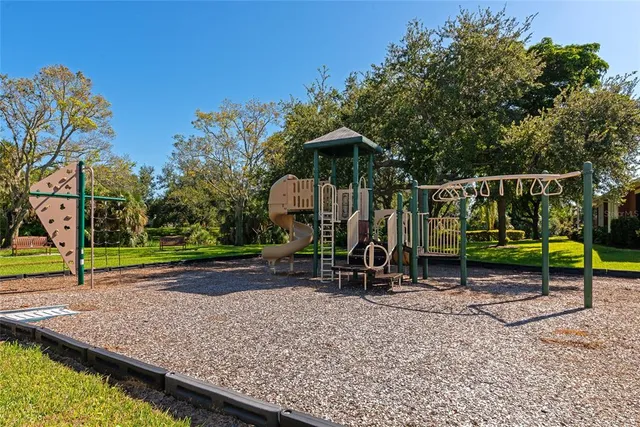 an aerial view of a city with lots of residential buildings ocean and mountain view in back