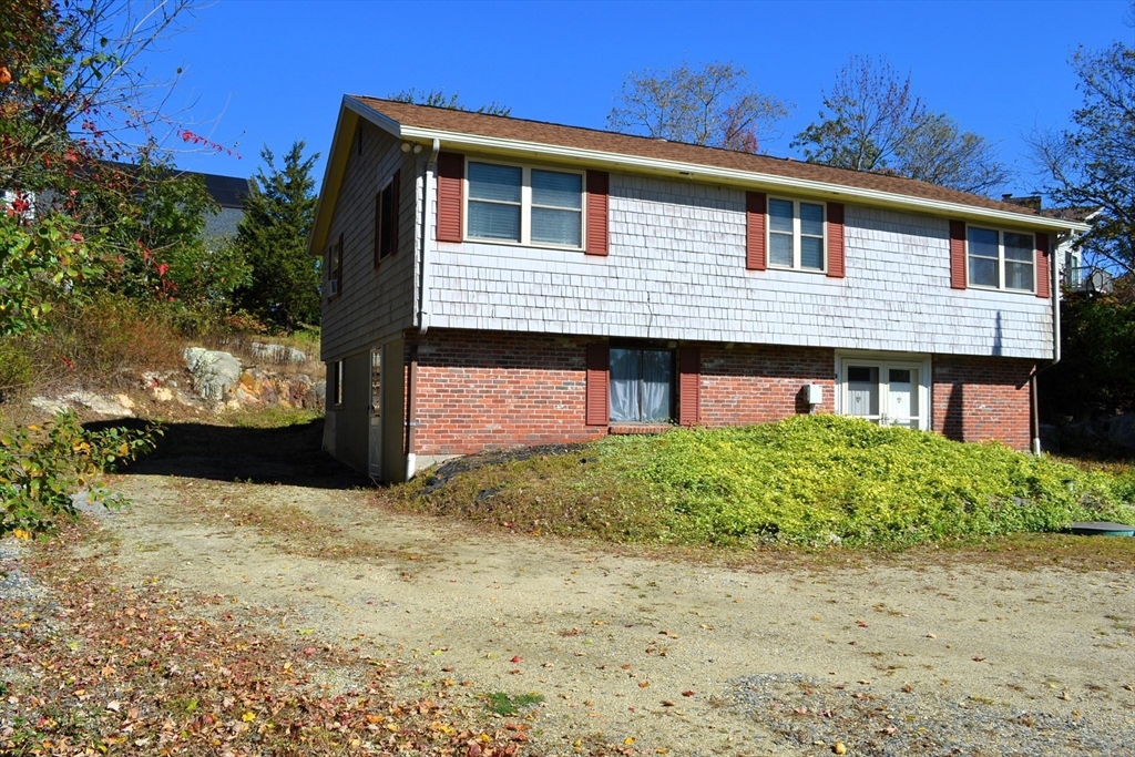 8 Jacques Lane Gloucester, MA 01930 - Photo 2 of 36 a front view of a house with a yard and garage
