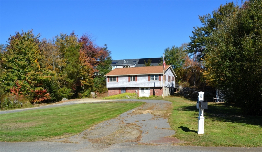8 Jacques Lane Gloucester, MA 01930 - Photo 31 of 36 a house with green field in front of it