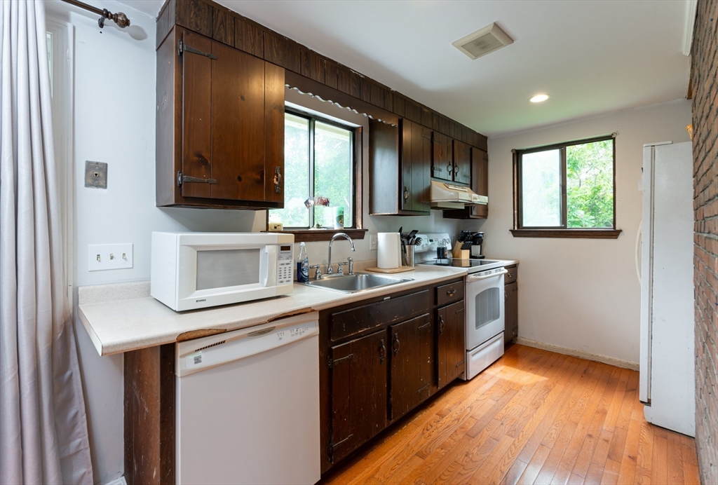 8 Jacques Lane Gloucester, MA 01930 - Photo 10 of 36 a kitchen with stainless steel appliances granite countertop a sink stove and cabinets