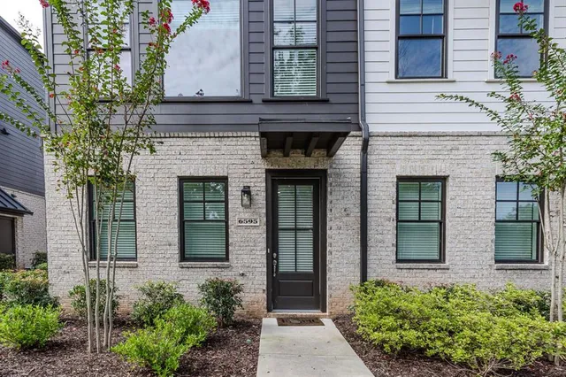 front view of a house with potted plants
