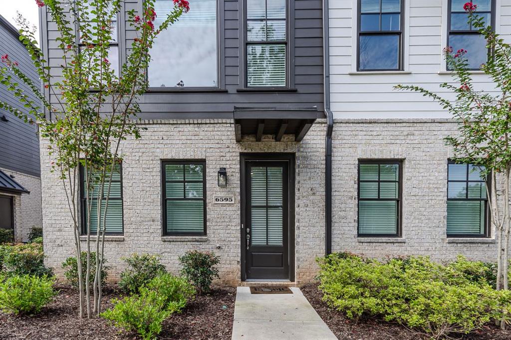 front view of a house with potted plants