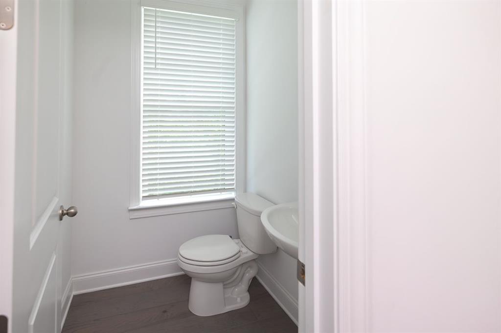 6595 Beacon Drive Atlanta, GA 30328 - Photo 20 of 36 a white toilet sitting next to a white sink