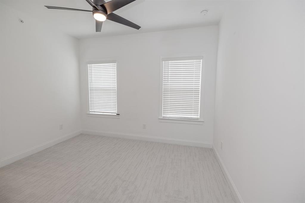 6595 Beacon Drive Atlanta, GA 30328 - Photo 23 of 36 an empty room with a window and a fan