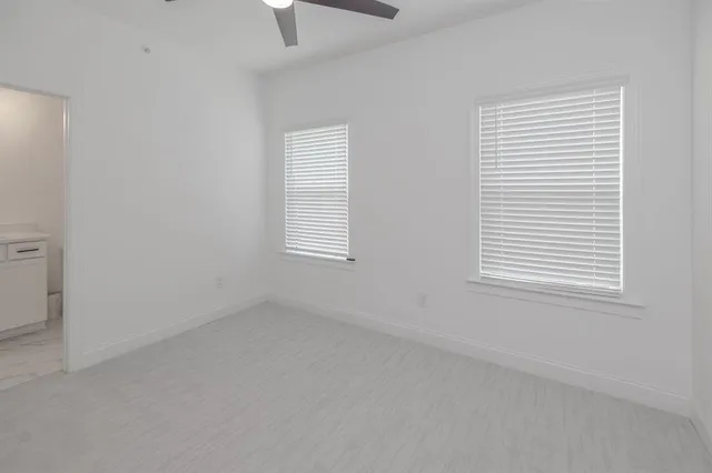 a white toilet sitting next to a bathroom sink