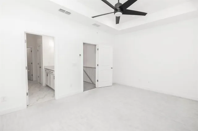 a spacious bathroom with a granite countertop sink and a mirror