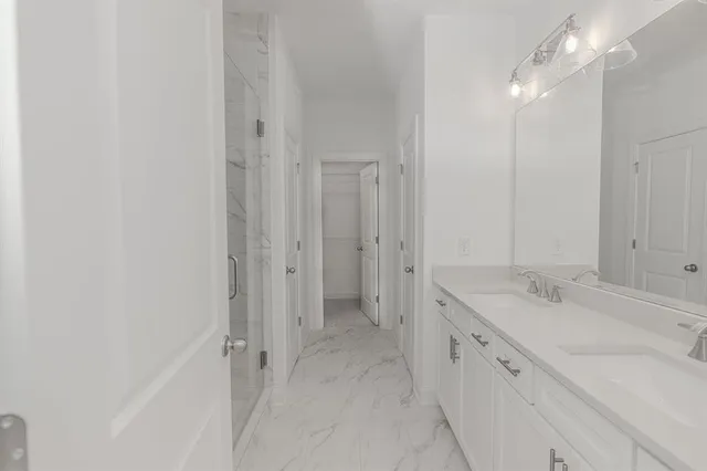 a bathroom with a glass shower door