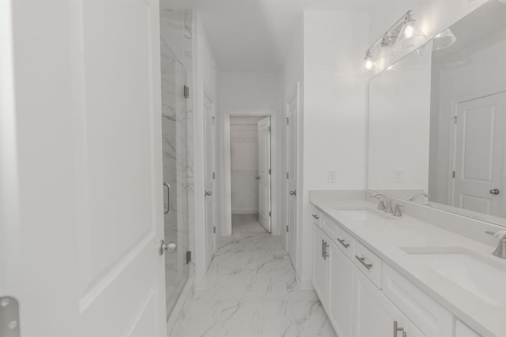6595 Beacon Drive Atlanta, GA 30328 - Photo 31 of 36 a spacious bathroom with a granite countertop sink and a mirror