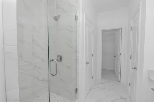 a bathroom with a glass shower door