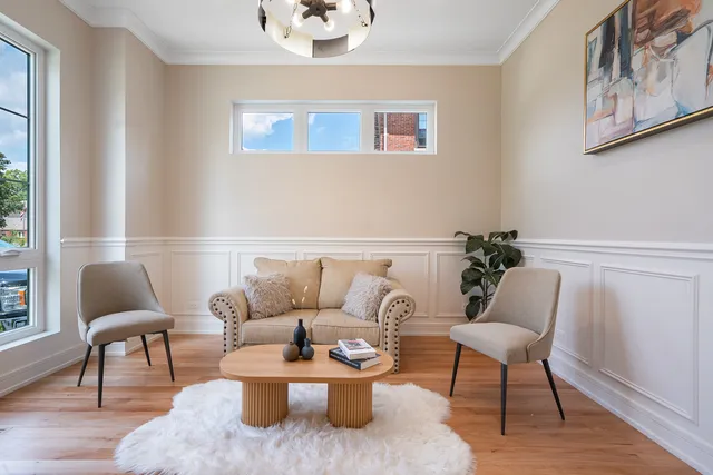 a living room with furniture and a potted plant