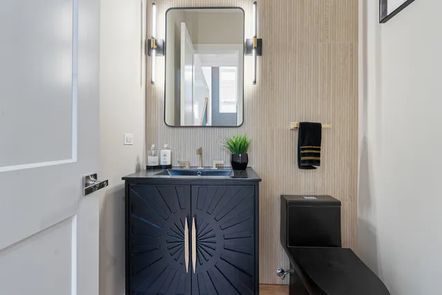 a bathroom with a sink a mirror and a toilet