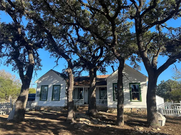 front view of a house with a tree