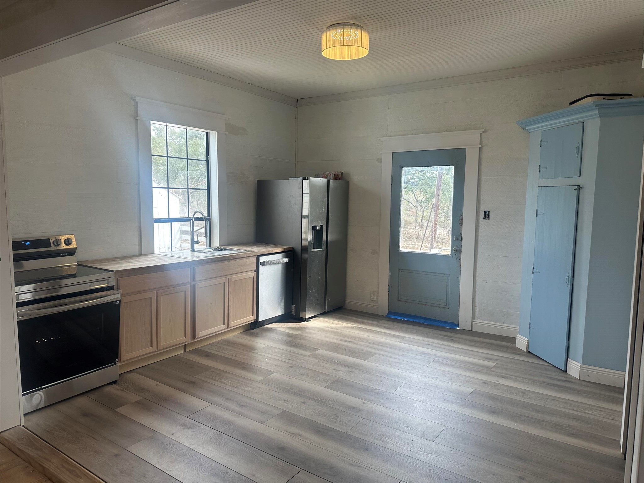 543 Narrows Road Blanco, TX 78606 - Photo 31 of 32 a kitchen with granite countertop a refrigerator and a stove top oven