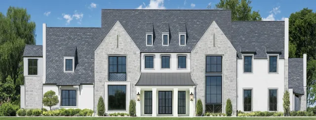 a view of a brick house with large windows