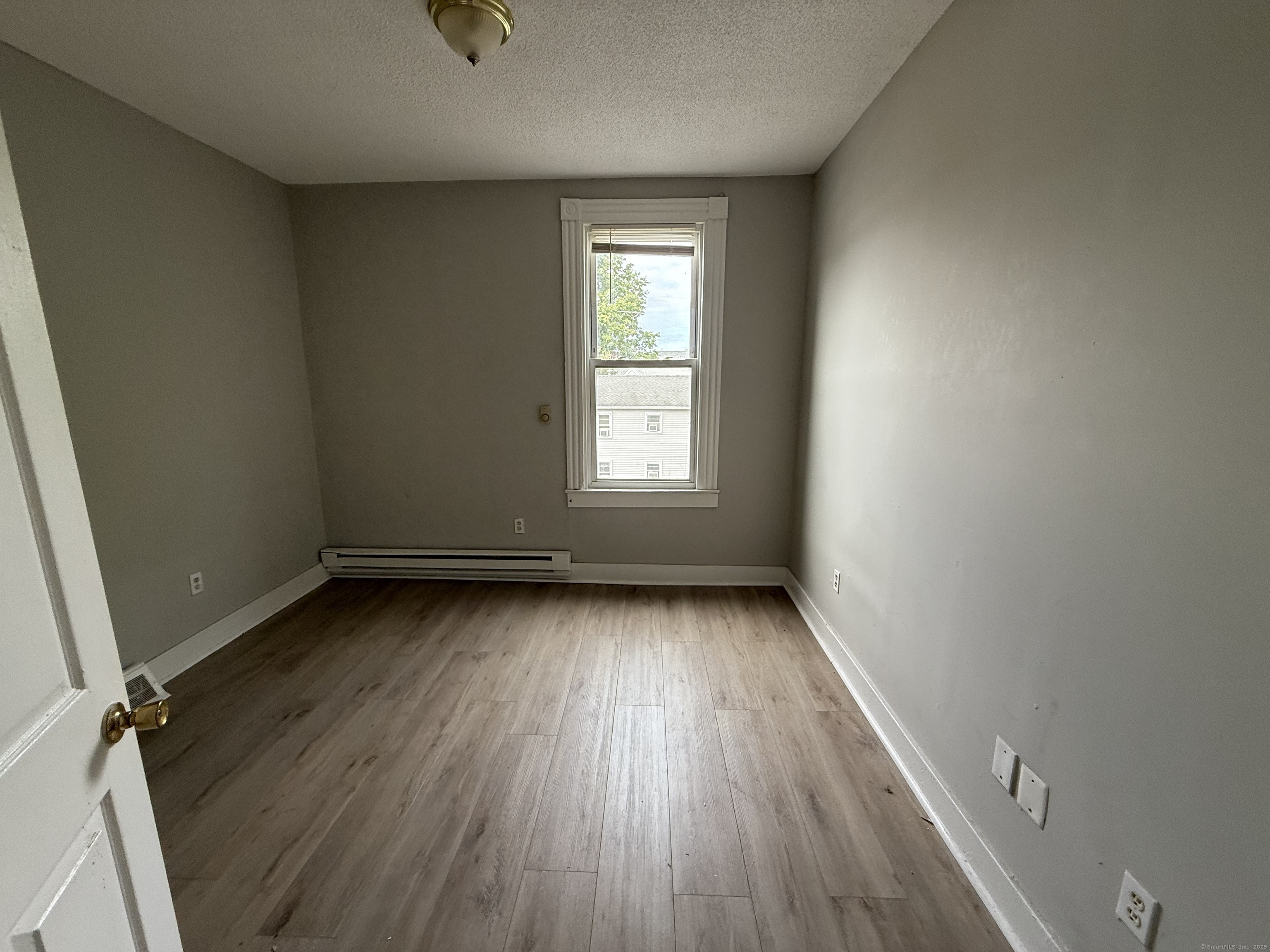 40 Shelton Avenue New Haven, CT 06511 - Photo 8 of 13 an empty room with wooden floor and windows