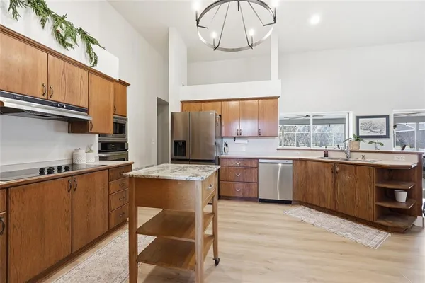 a kitchen with a sink cabinets and window
