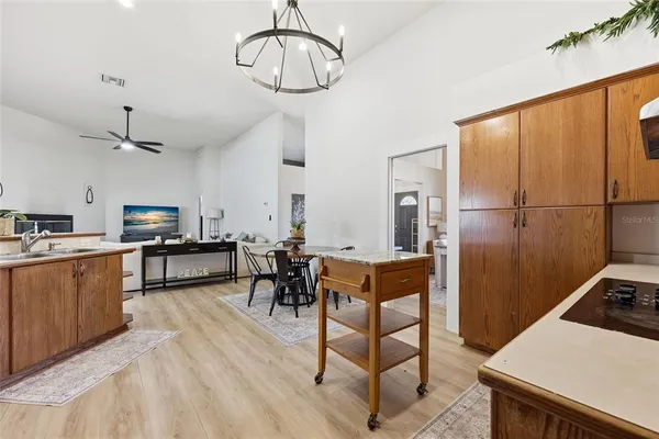 a kitchen with stainless steel appliances a stove a refrigerator and dining table