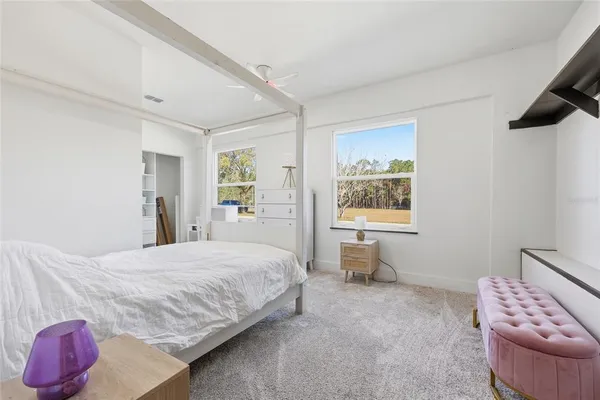 a bedroom with a bed and a window