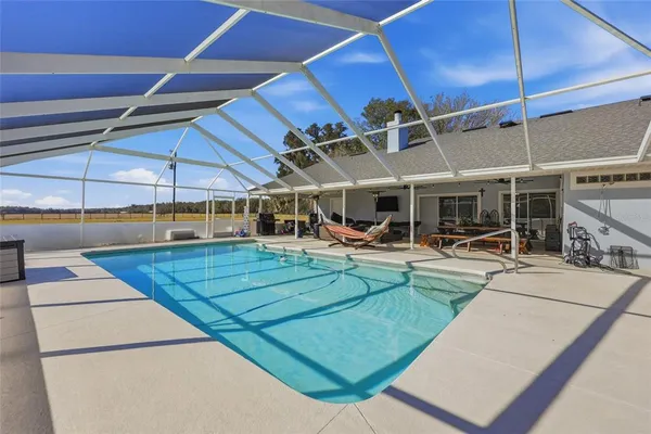 a view of a swimming pool with sitting area