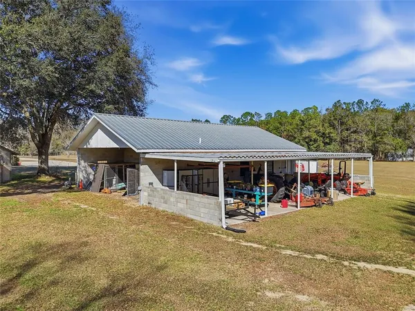 a view of a house with a backyard porch and sitting area