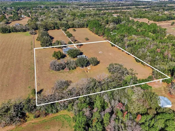 an aerial view of house with yard