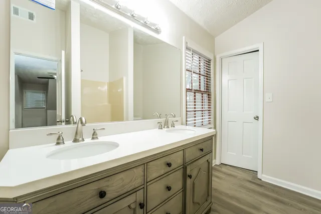 a bathroom with a sink double vanity and a mirror