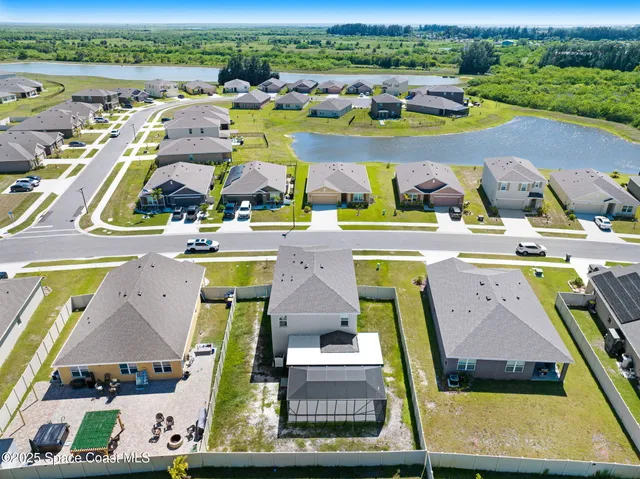 an aerial view of houses with a swimming pool