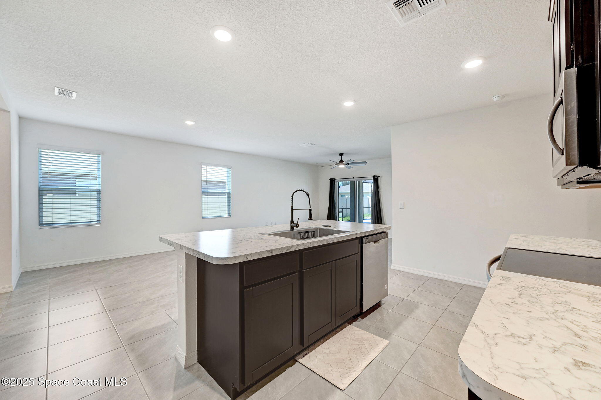 1217 Casey Avenue Rockledge, FL 32955 - Photo 16 of 49 a kitchen with stainless steel appliances granite countertop a sink and dishwasher with white cabinets