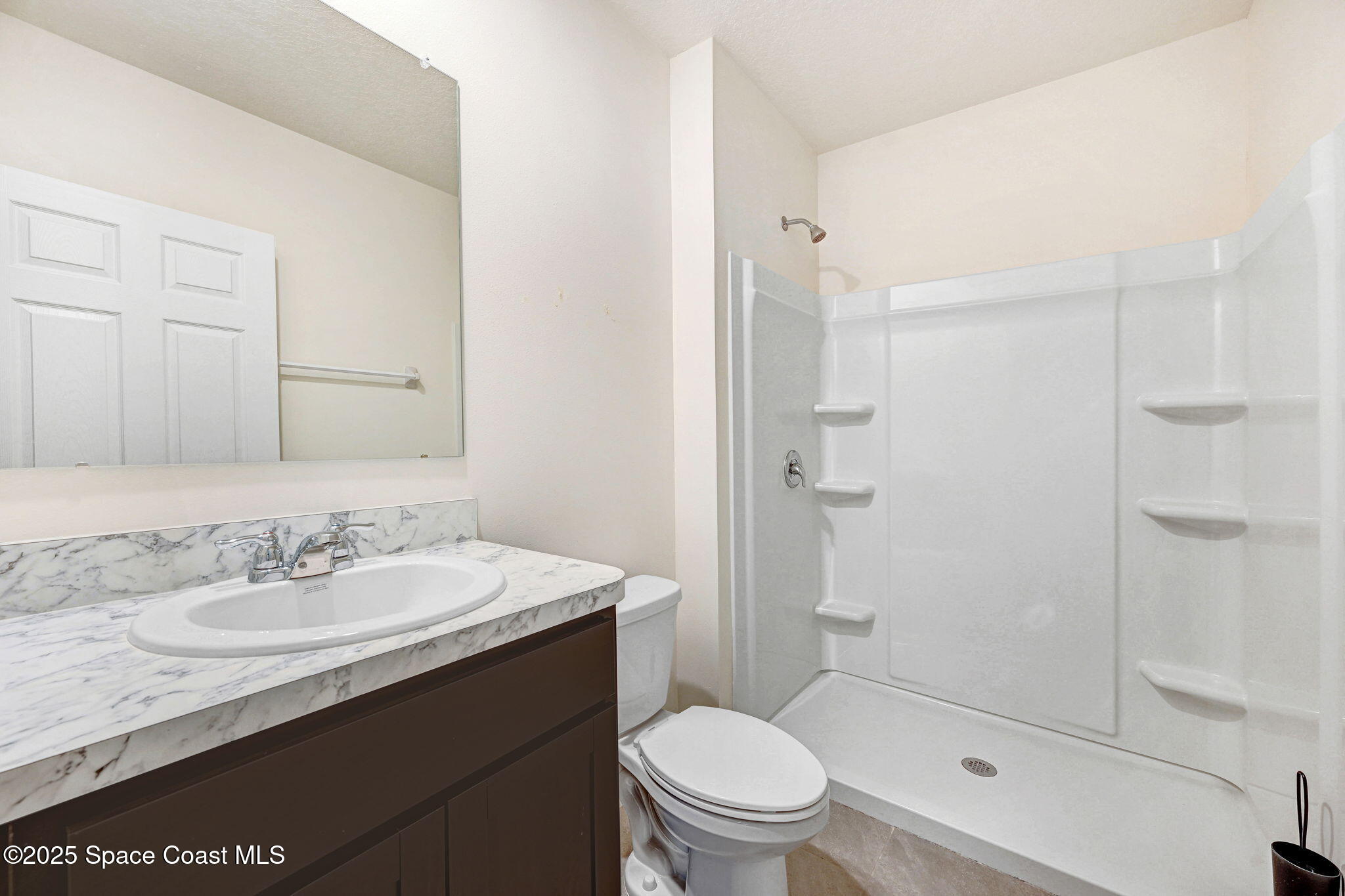 1217 Casey Avenue Rockledge, FL 32955 - Photo 20 of 49 a bathroom with a sink toilet vanity and shower