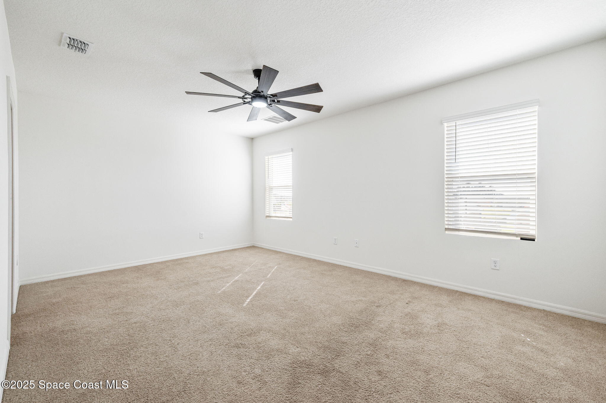 1217 Casey Avenue Rockledge, FL 32955 - Photo 25 of 49 an empty room with a window and a fan