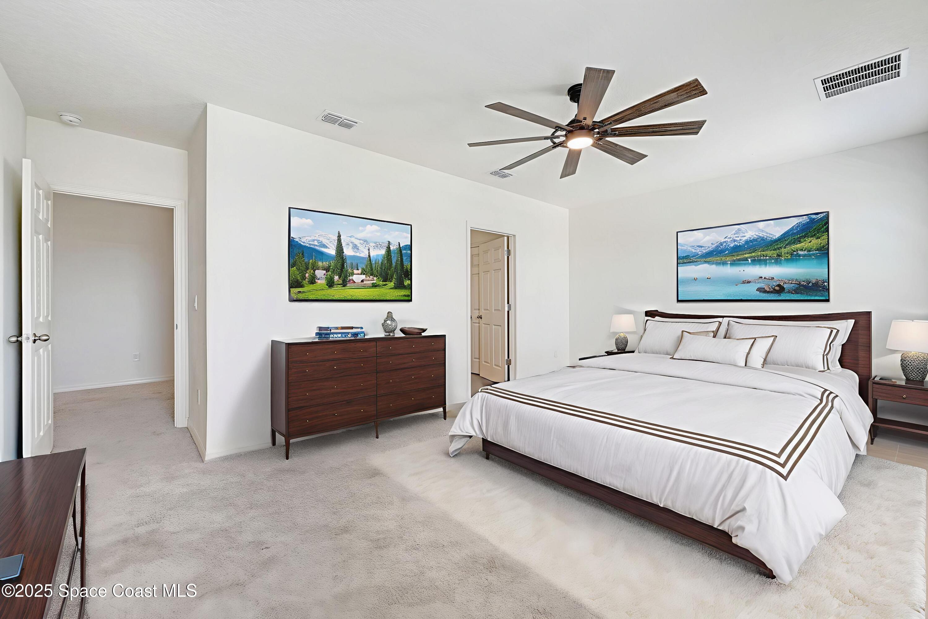 1217 Casey Avenue Rockledge, FL 32955 - Photo 28 of 49 a spacious bedroom with a bed and a chandelier