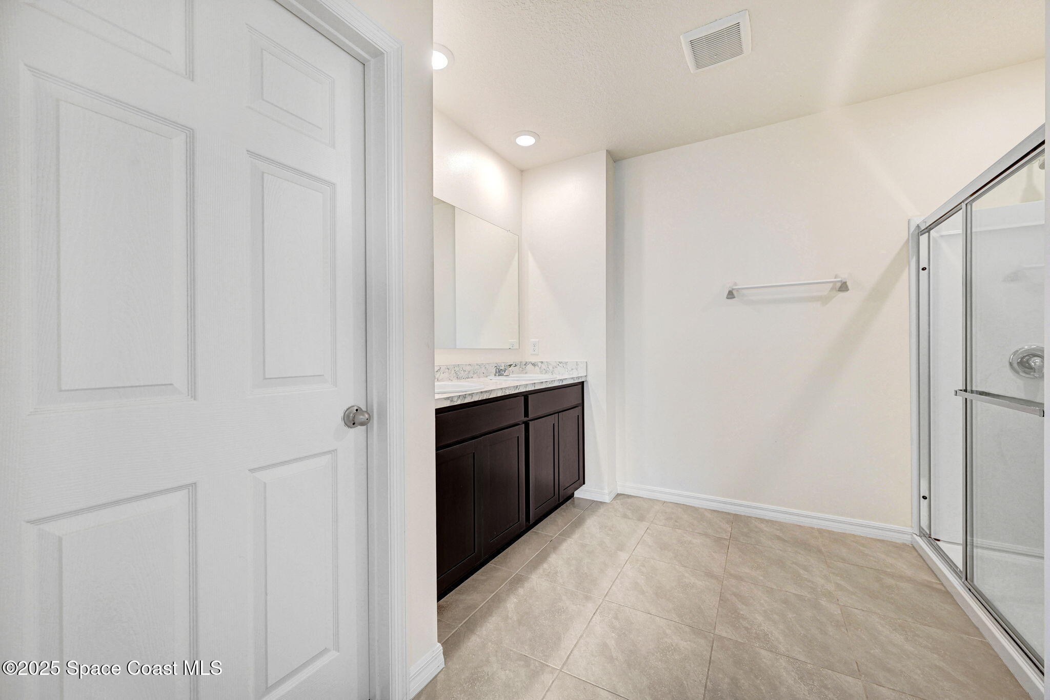 1217 Casey Avenue Rockledge, FL 32955 - Photo 29 of 49 a bathroom with a double vanity sink a toilet and shower