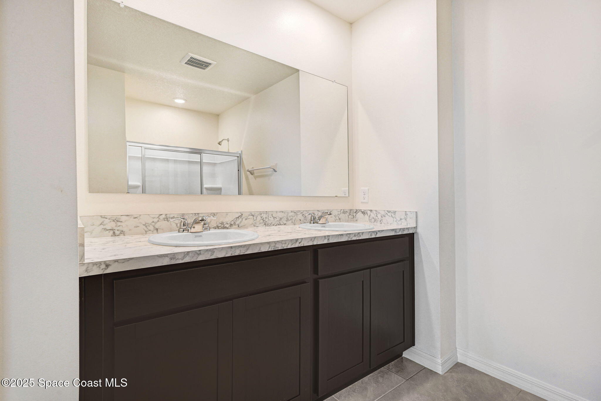 1217 Casey Avenue Rockledge, FL 32955 - Photo 30 of 49 a bathroom with a granite countertop sink and a mirror