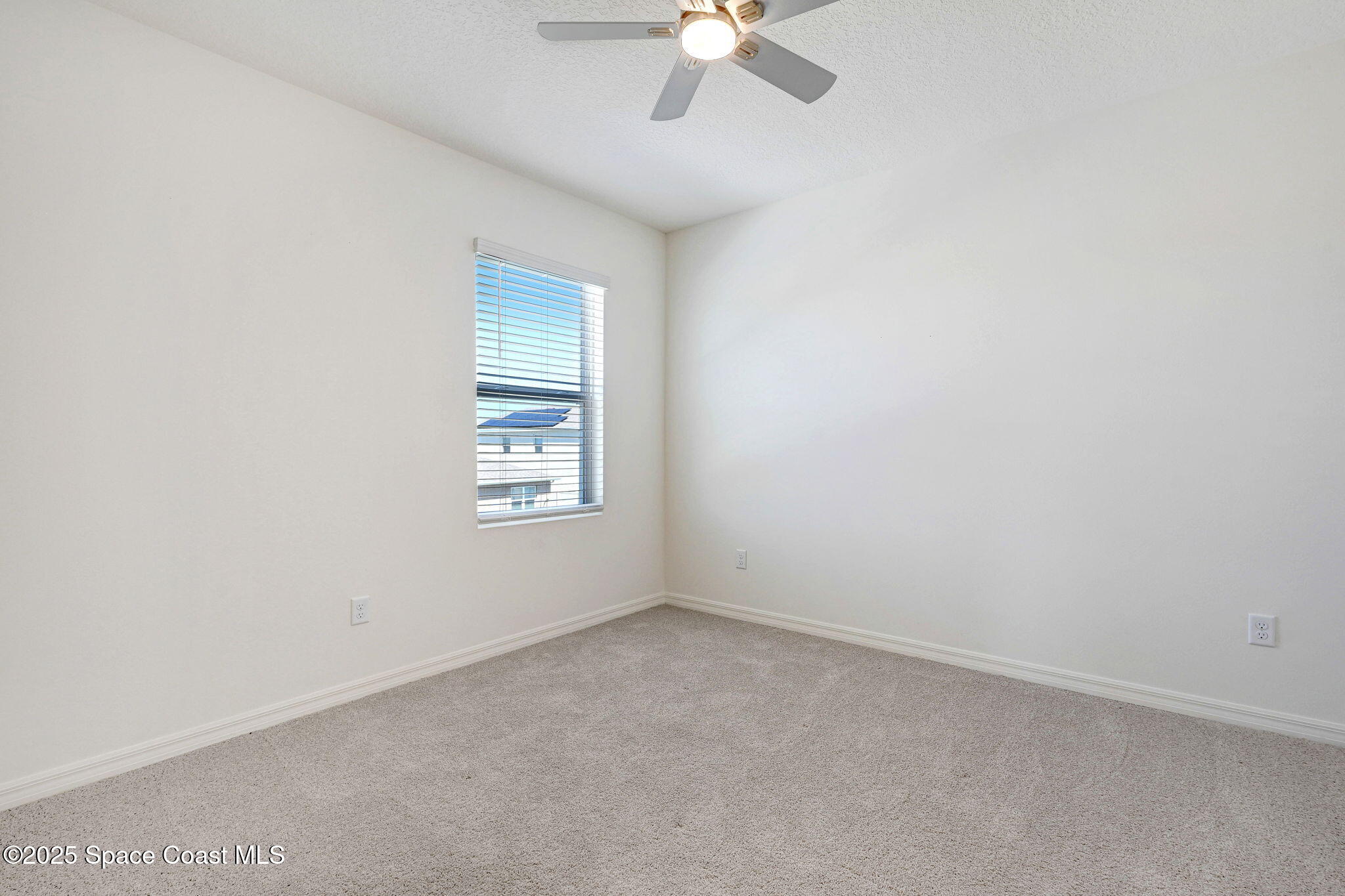 1217 Casey Avenue Rockledge, FL 32955 - Photo 36 of 49 an empty room with a chandelier fan and windows